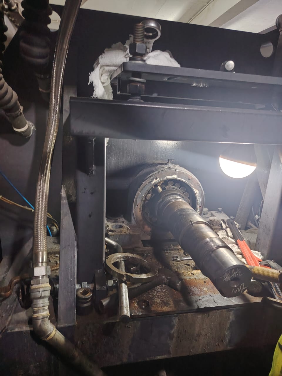 Shaft with a spherical roller bearing exposed and tools laid around it